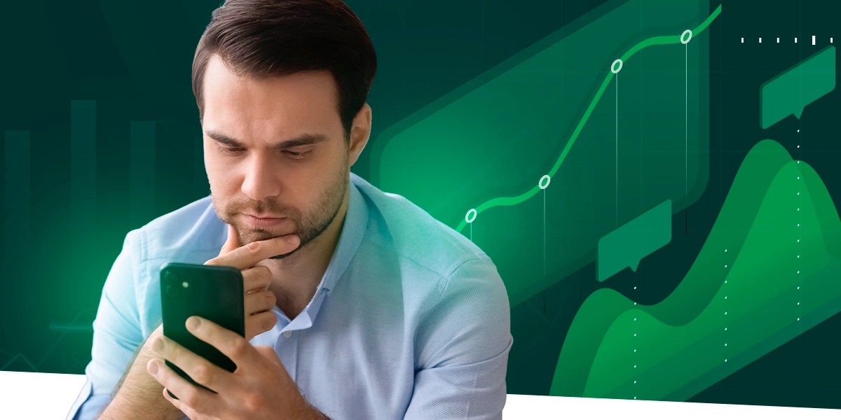 Imagem mostra homem pensativo ao celular. Ao fundo, um gráfico.